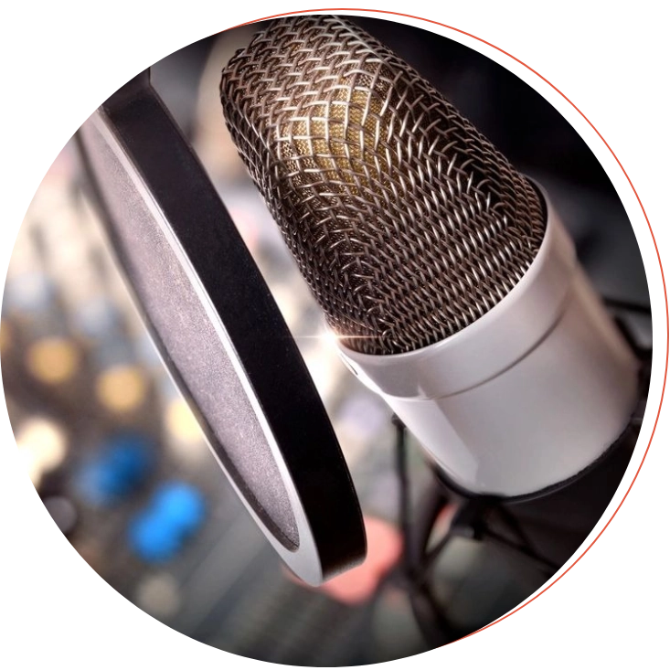 Close-up of a condenser microphone with a pop filter in a recording studio.